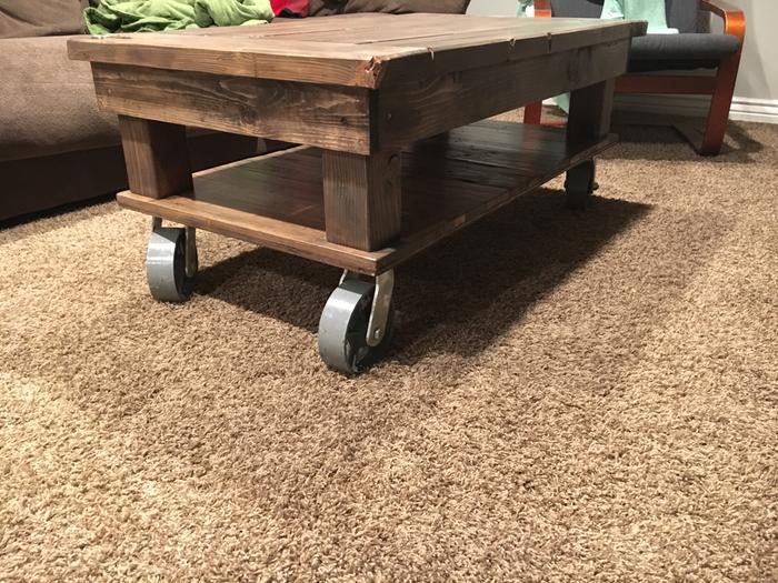 Wood coffee table with casters as wheels